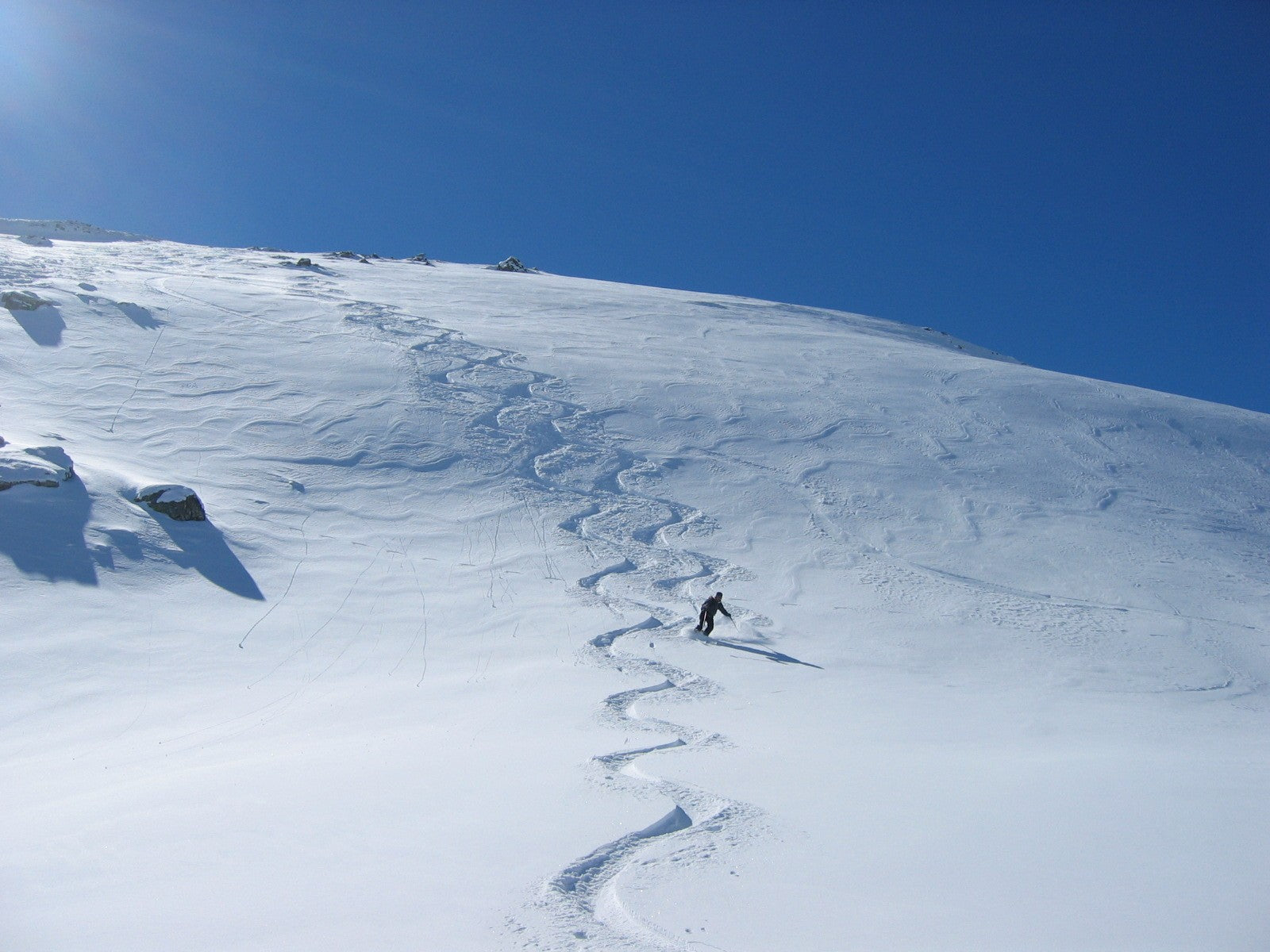 Skier moving across an alpine slope