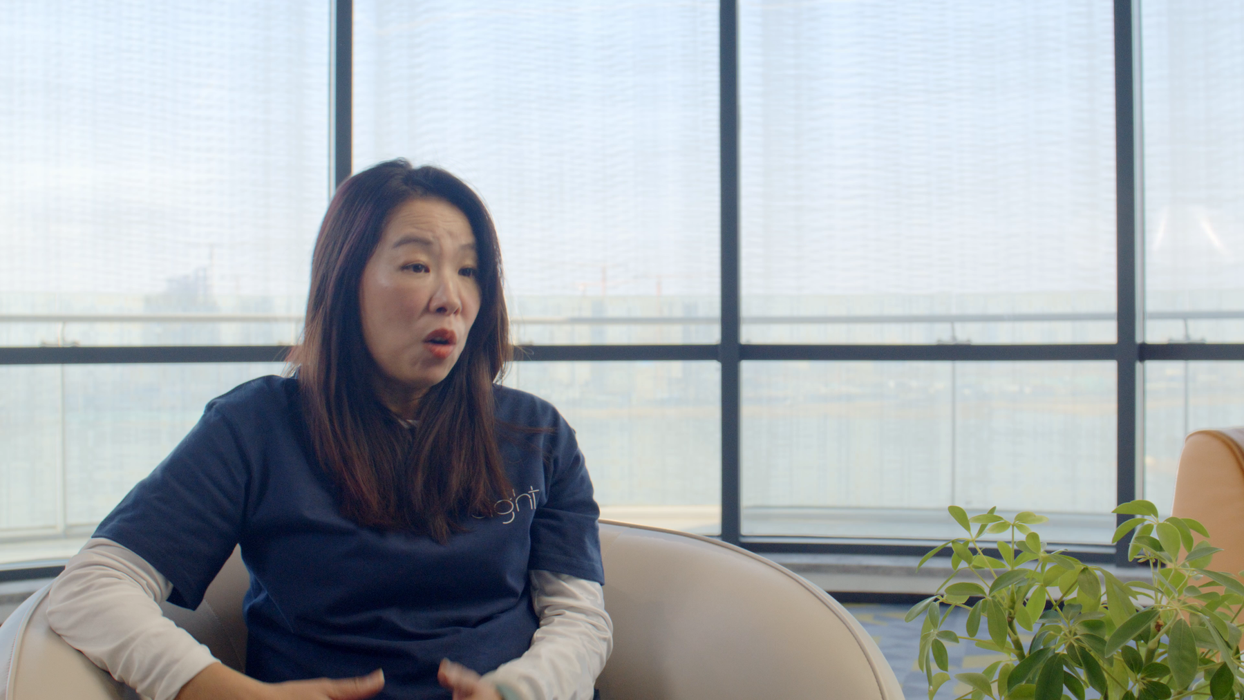 8ight team member speaking during an interview beside a bright studio window