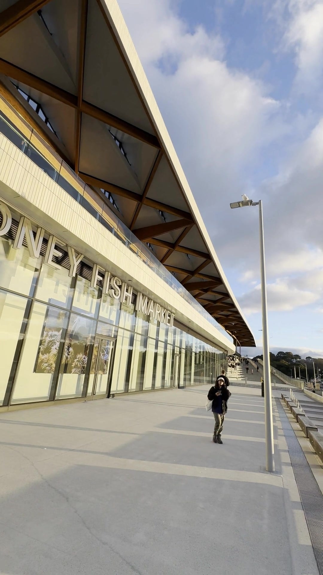 First-person walk along a public waterfront at sunset